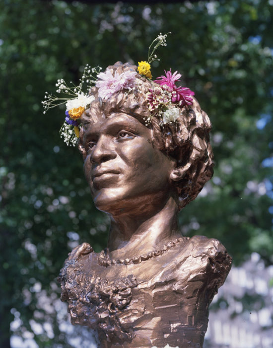 bronze statue of marsha p johnson, with flower crown