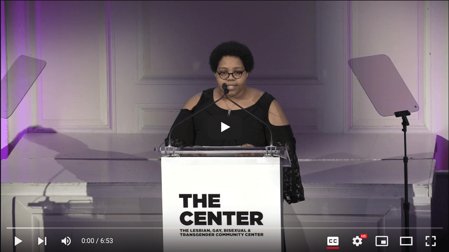 Tatiana B. Martin speaking at the podium of the 2021 Women's Center for the NYC LGBTQ Community Center