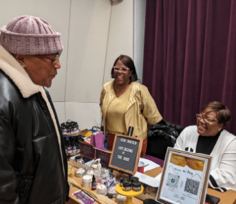 Visitor to the black holiday market with a table of products
