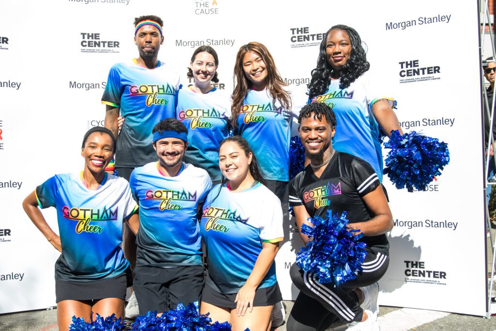 cheerleaders pose for a picture in front of a backdrop with The Center's and Morgan Stanley logos