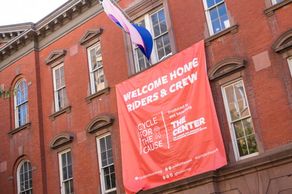 a huge banner hangs high in front of The Center. It says Welcome Home Riders & Crew