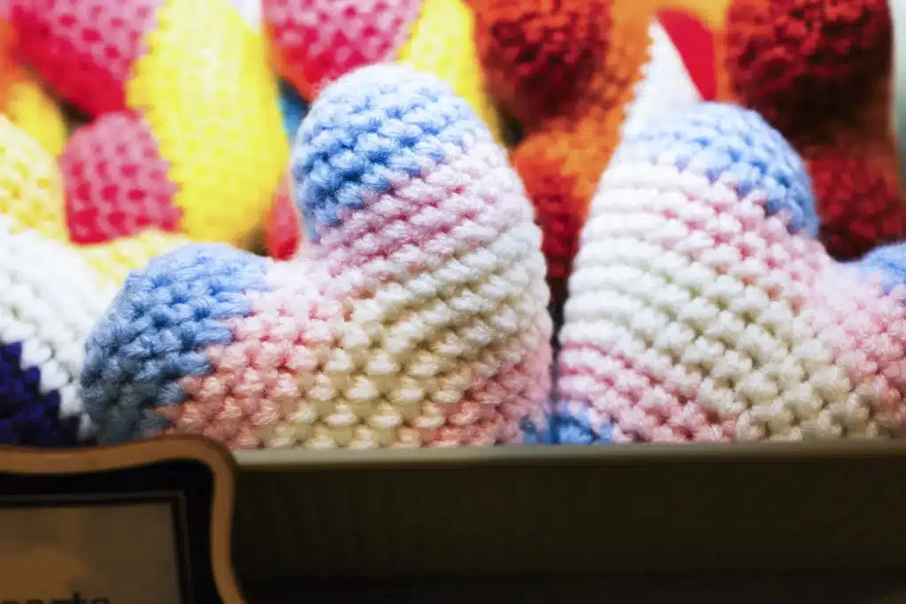 two crocheted hearts in transgender flag colors