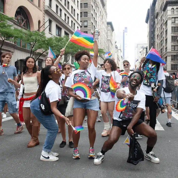 Queer folks waving LGBT, Lesbian, Bisexual and Trans Flags